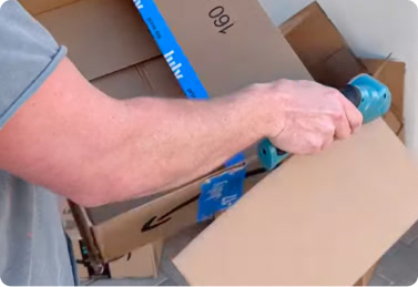 Customer cutting thick cardboard with the BoxHound cutter