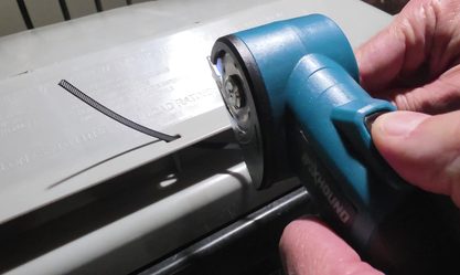 BoxHound cutter on a workbench next to a tape measure and square