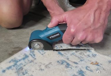 Customer trimming carpet with the BoxHound cutter