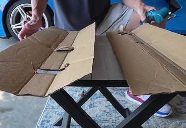 Shipping box cut cleanly in two on a garage workbench