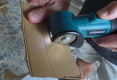 Customer cutting thick cardboard with the BoxHound cutter